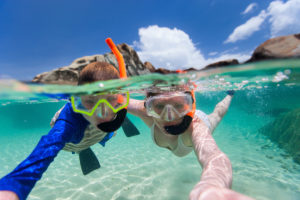 family-snorkeling-in-tropical-water